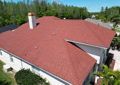 Drone shot of a residential roof with solar panels installed, showcasing the energy-efficient solutions provided by Smart Volt Solutions.