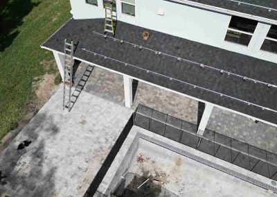 Solar Panel Rails Installed on Residential Roof Above Patio