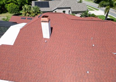 Aerial view of a red roof with a chimney, prepared for solar panel installation by Smart Volt Solutions.