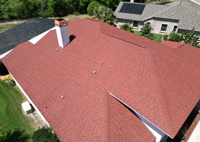 Aerial view of a red shingle roof, showing preparation work for solar panel installation by Smart Volt Solutions.