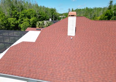 Aerial view of a red shingled roof with solar panel installation preparations by Smart Volt Solutions.