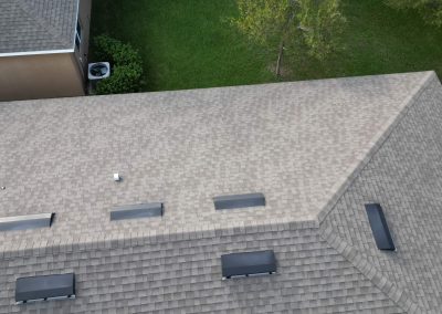 Aerial view of a residential roof showing ventilation details and evaluation for solar energy system installation.