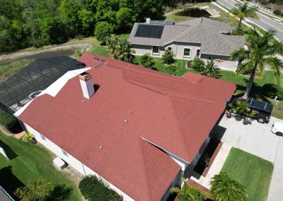 Aerial view of a red shingle roof, showing preparation work for solar panel installation, managed by Smart Volt Solutions.