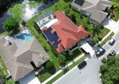 Aerial view of a home with solar panels installed on the roof, showcasing Smart Volt Solutions' efficient solar energy systems.