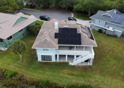 Aerial view of a house with solar panels installed by Smart Volt Solutions, showcasing the modern energy-efficient upgrade.