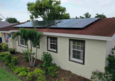 Solar-Powered Home with Lush Greenery and Palm Trees