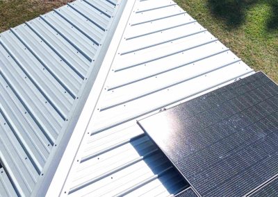 Sunlit Solar Panels on Metal Roof Corner