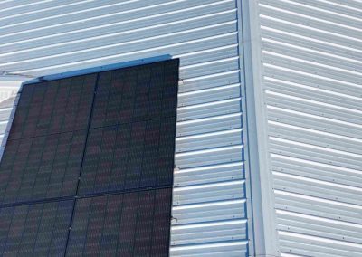 Vertical Solar Panels Aligned on Metal Roof