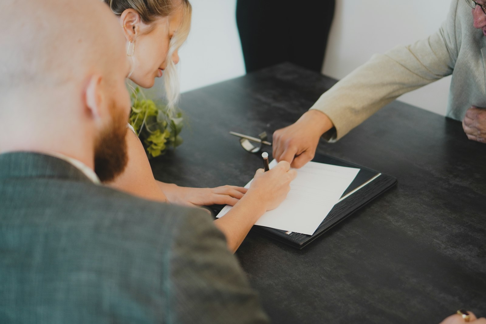 Couple reviewing and signing a prepaid solar lease contract at their kitchen table